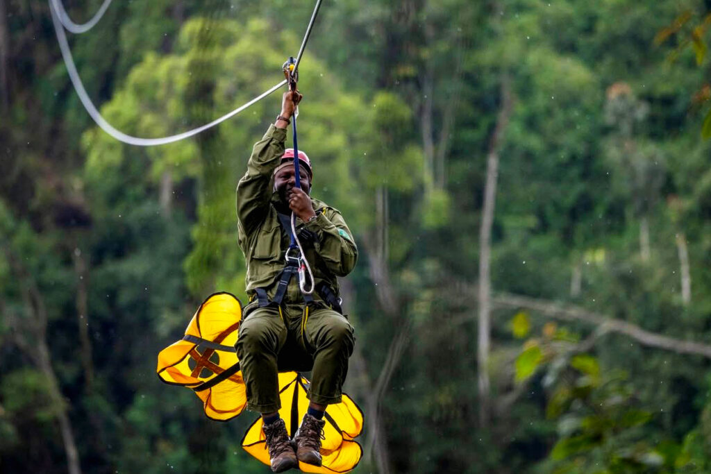Tourist flying through Nyungwe treetops on zipline with Ibigwi Tours